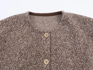Close-up of vintage knit cardigan with round neck and detailed wooden star buttons