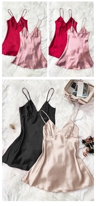 Detail of silk satin nightdress in four colors displayed on a cozy plush rug