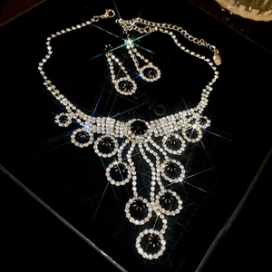 Detail of luxury rhinestone circle tassel necklace and earrings jewelry set in a box