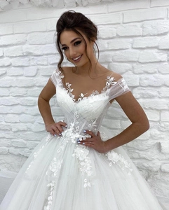 Exquisite off-shoulder wedding dress with delicate floral lace and 3D petal embroidery