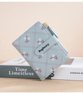 Detail of light blue floral wallet on a book with diamond pattern and brand buckle