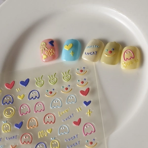 Detail view of 3D embossed nail stickers with colorful hearts and cute cartoon motifs