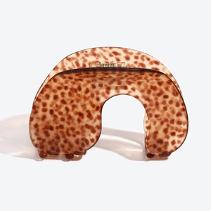 Détail d'une pince à cheveux incurvée à motif léopard en acétate marron translucide