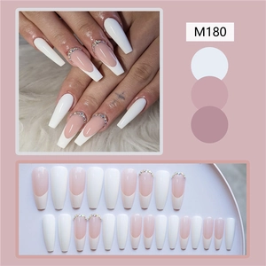 Detail view of M180 long ballerina French press-on nails with rhinestones and white tips