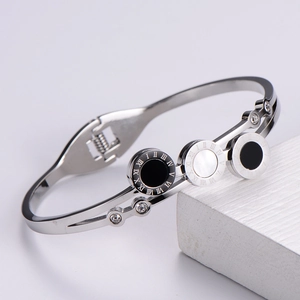 Detail of silver bangle with Roman numerals, black and white shell inlays and zircons