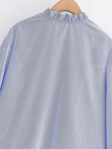 Detailed view of blue striped poplin shirt featuring elegant ruffled collar trim