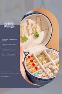 Close-up of portable round jewelry box with necklace hooks and ring slots in blue leather