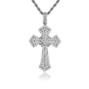 Macro view of silver cross pendant with inlaid zircons and a twisted rope chain necklace