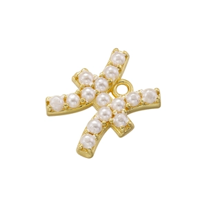 Detailed macro view of gold-plated cross lines pendant with inlaid white pearls