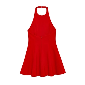 Close-up of the back detail on a red halter dress featuring a concealed zipper and waist cut
