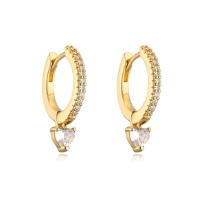 Close-up of gold heart earrings with zircon crystals and sleek polished finish