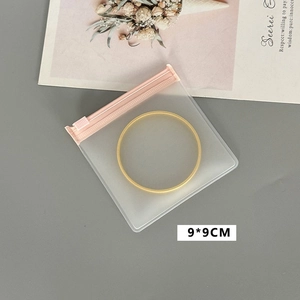 Detail view of a 9x9cm semi-transparent frosted jewelry bag with secure zip closure