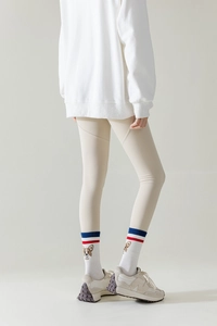 Detail of white cotton yoga toe socks with corgi embroidery and red blue stripes