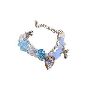 Double-layered beaded bracelet with silver heart pendant and blue beads on white background