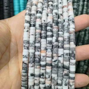 Macro shot of natural stone spacer beads with unique zebra patterns for jewelry making