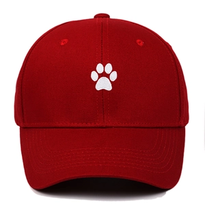 Close-up of high-quality white cat paw embroidery on dark red cotton baseball cap