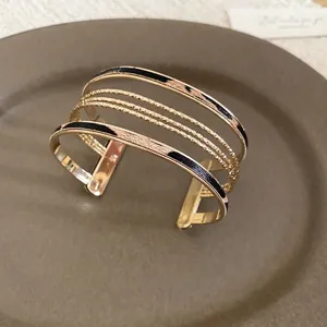 Chic multi-layer wide cuff bracelet in gold finish with leopard print and black accents