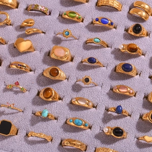 Gold stainless steel rings set with natural stones and heart sun motifs on velvet