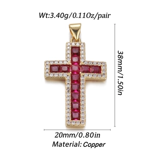 Macro detail of gold cross pendant with red gemstones showing precise 38x20mm dimensions