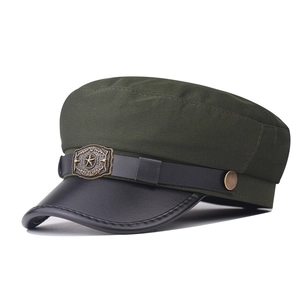 Close-up of military flat top cap with pentagram badge and leather strap detail