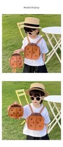 Outdoor lifestyle view of orange ladybug backpack on child model in a sunny grass field
