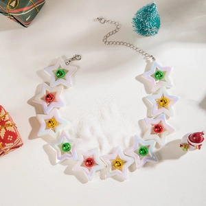 Detailed view of colorful Christmas bell star pendants with festive holiday props and snow