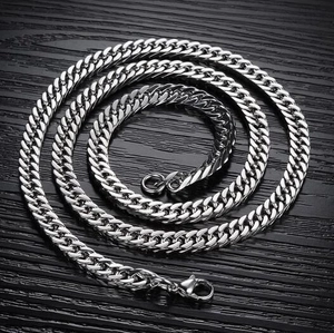 Polished silver stainless steel Cuban link necklace with lobster clasp on black wood