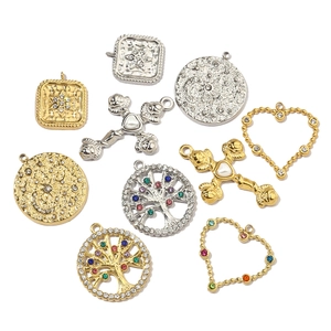 Various Tree of Life and geometric stainless steel charms in gold and silver finishes