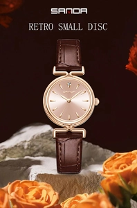 Close-up of vintage quartz watch with brown leather strap and rose gold round dial