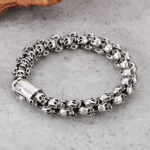 Macro detail of gothic skull bracelet in vintage silver finish on stone texture
