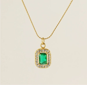 Macro detail of gold square emerald pendant necklace with pavé cubic zirconia