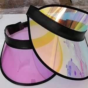 Detail of colorful and purple transparent PVC sun visor caps with black leather trim finish