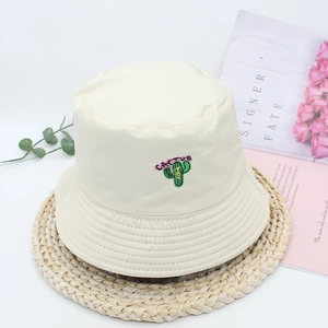 Beige canvas bucket hat featuring colorful cactus embroidery and a wide stitched brim