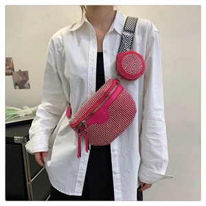 Detail of rose red rhinestone crossbody bag with silver studs and striped strap