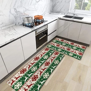 Detailed view of red reindeer and white snowflake patterns on festive Christmas kitchen mats