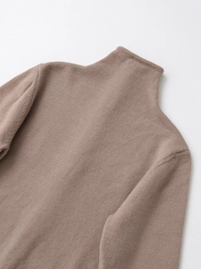 Close-up of the fine knit texture and high neck stitching on this coffee brown sweater