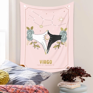 Detail of light pink Virgo zodiac tapestry with floral hands and stars on a bedroom wall