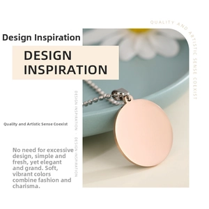 Polished rose gold round pendant necklace with bead chain shown on a ceramic dish