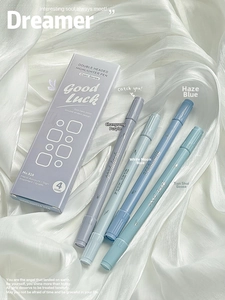 Macro detail of gradient double-headed highlighters on white silk with gift packaging