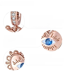 Macro detail of rose gold S925 sterling silver heart charm with blue devil eye cubic zirconia