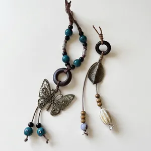 Bohemian necklaces with butterfly and leaf pendants, wood beads, and ceramic charms