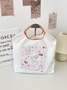 Detail of white canvas tote with pink star embroidery and motivational typography