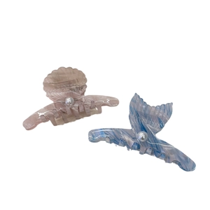 Pink shell and blue fishtail acrylic hair claws with marble texture and pearl accents
