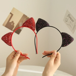Detail showing two cat ear headbands in red and black with glitter sequins for girls