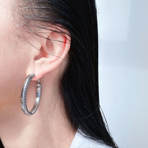 Silver spring-textured large hoop earrings with high-polish metallic finish for women