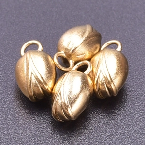 Macro view of four 18k gold plated stainless steel flower bud pendants for DIY jewelry