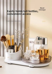 Detailed view of white rotating cosmetic organizer with gold jewelry tree and clear trays
