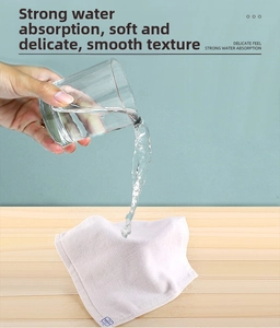 Macro shot demonstrating the high water absorption capacity of the white cotton towel