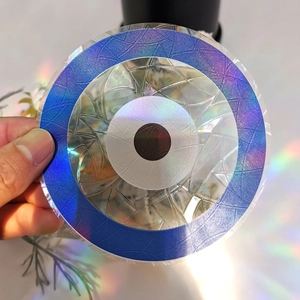 Rainbow prism suncatcher showing holographic light reflection on a circular PVC decal