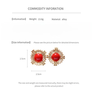 Detail view of vintage round earrings with red dome center and sparkling rhinestones